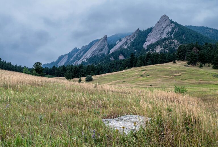 Sunrise over the Flatirons and meadow at Chautauqua Park with warm directional light